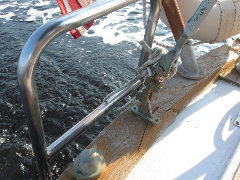 Backstay through wood cap rail